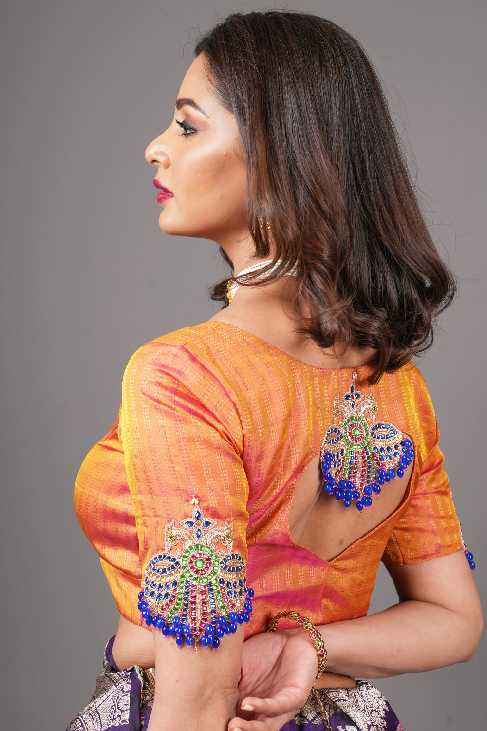 Kesari pure kanjivaram silk close neck blouse with handworked motifs on back and sleeves.