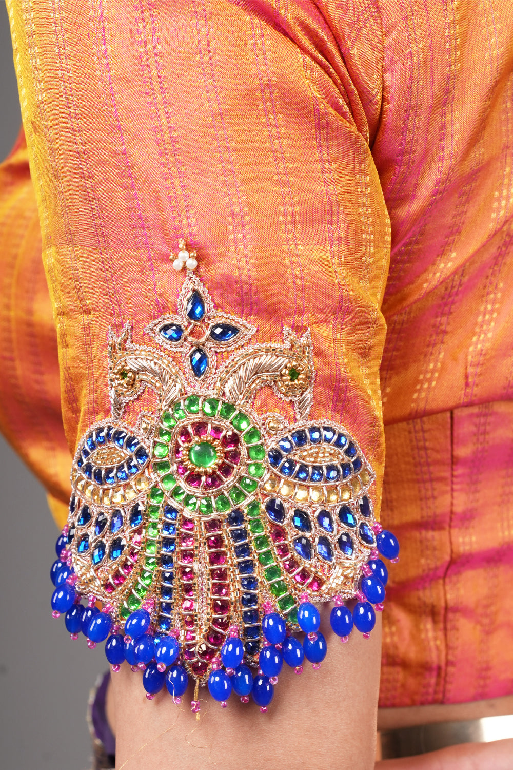 Kesari pure kanjivaram silk close neck blouse with handworked motifs on back and sleeves.