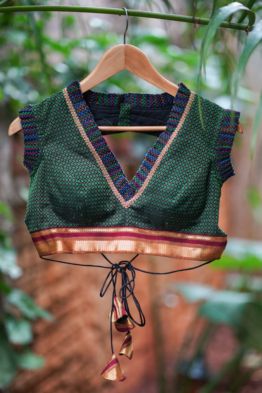 Dark green & black khana silk V neck blouse with frill detailing and backless design