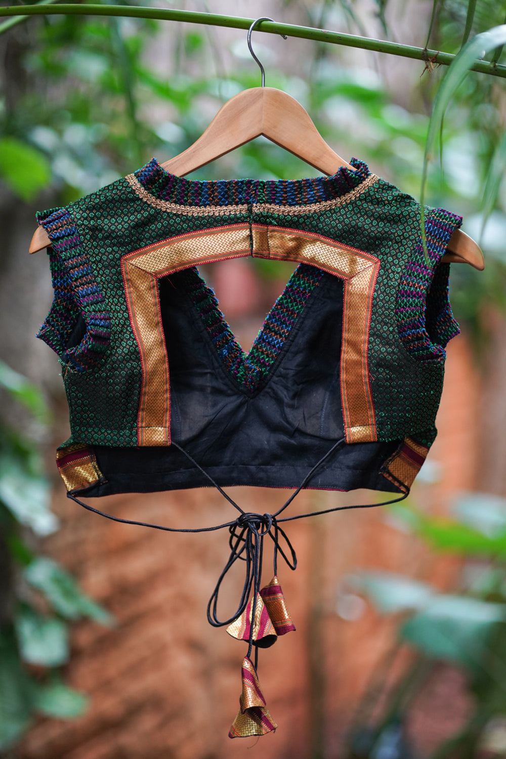 Dark green & black khana silk V neck blouse with frill detailing and backless design