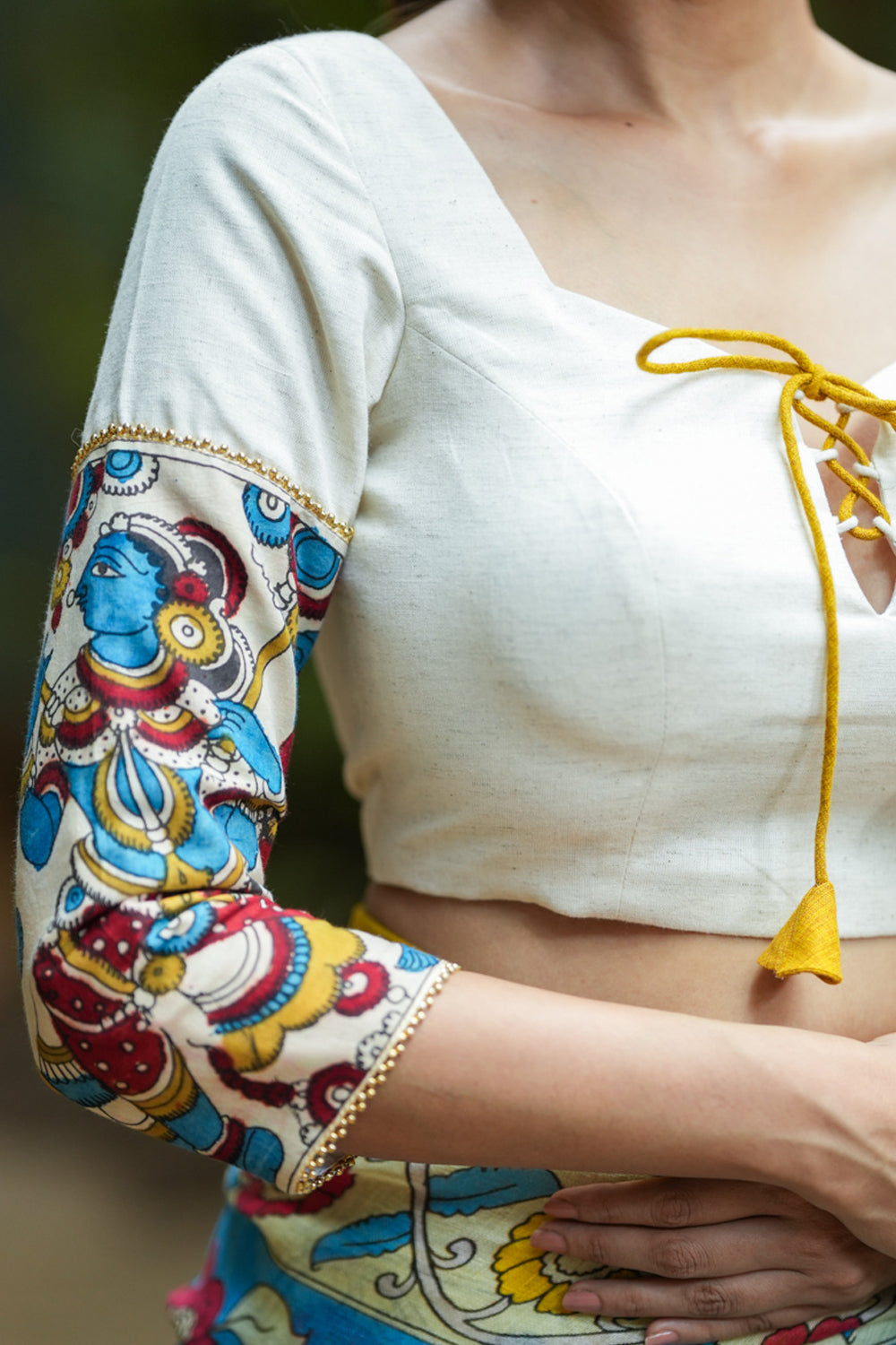 Porcelain white square neck blouse with handpainted kalamkari sleeve detailing.