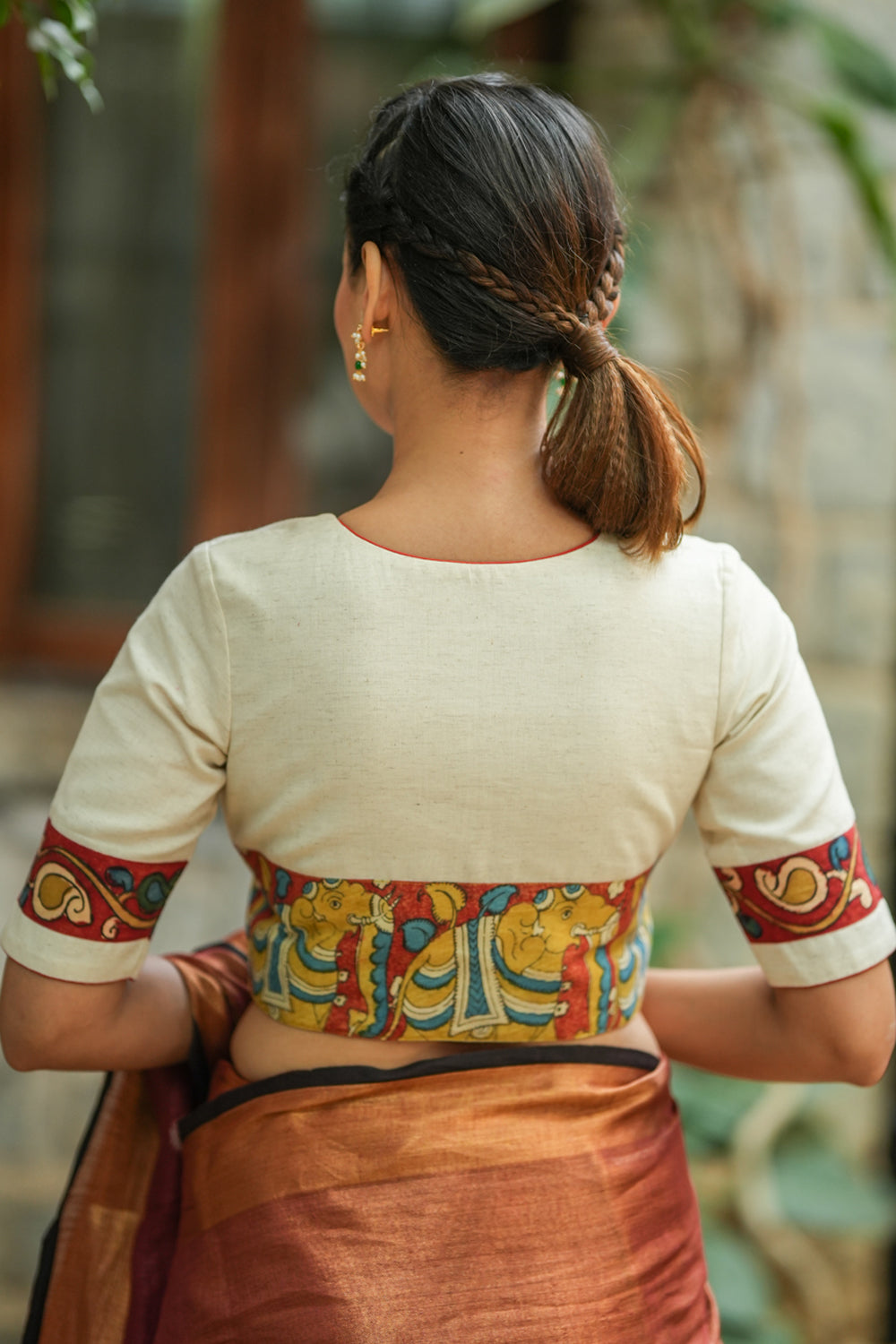 Daisy white V neck blouse with handpainted kalamkari border.