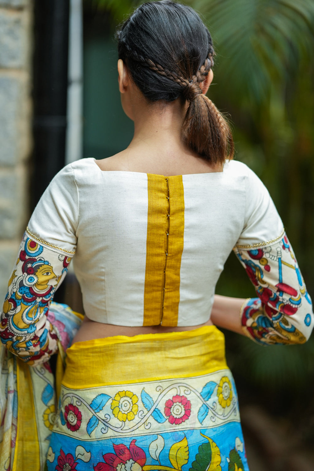 Porcelain white square neck blouse with handpainted kalamkari sleeve detailing.