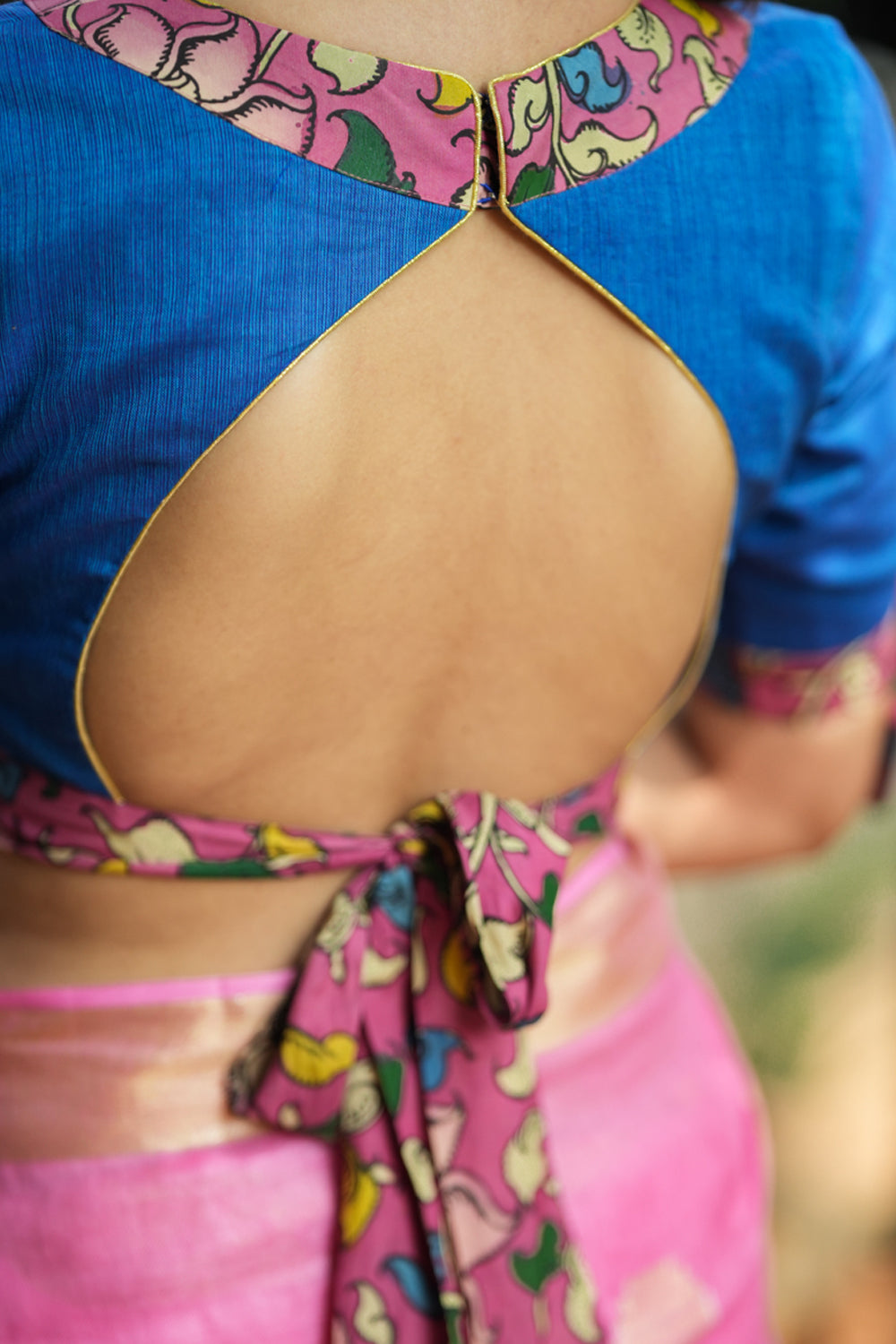 Ocean blue handloom V neck blouse with rose pink handpainted kalamkari border detailing.