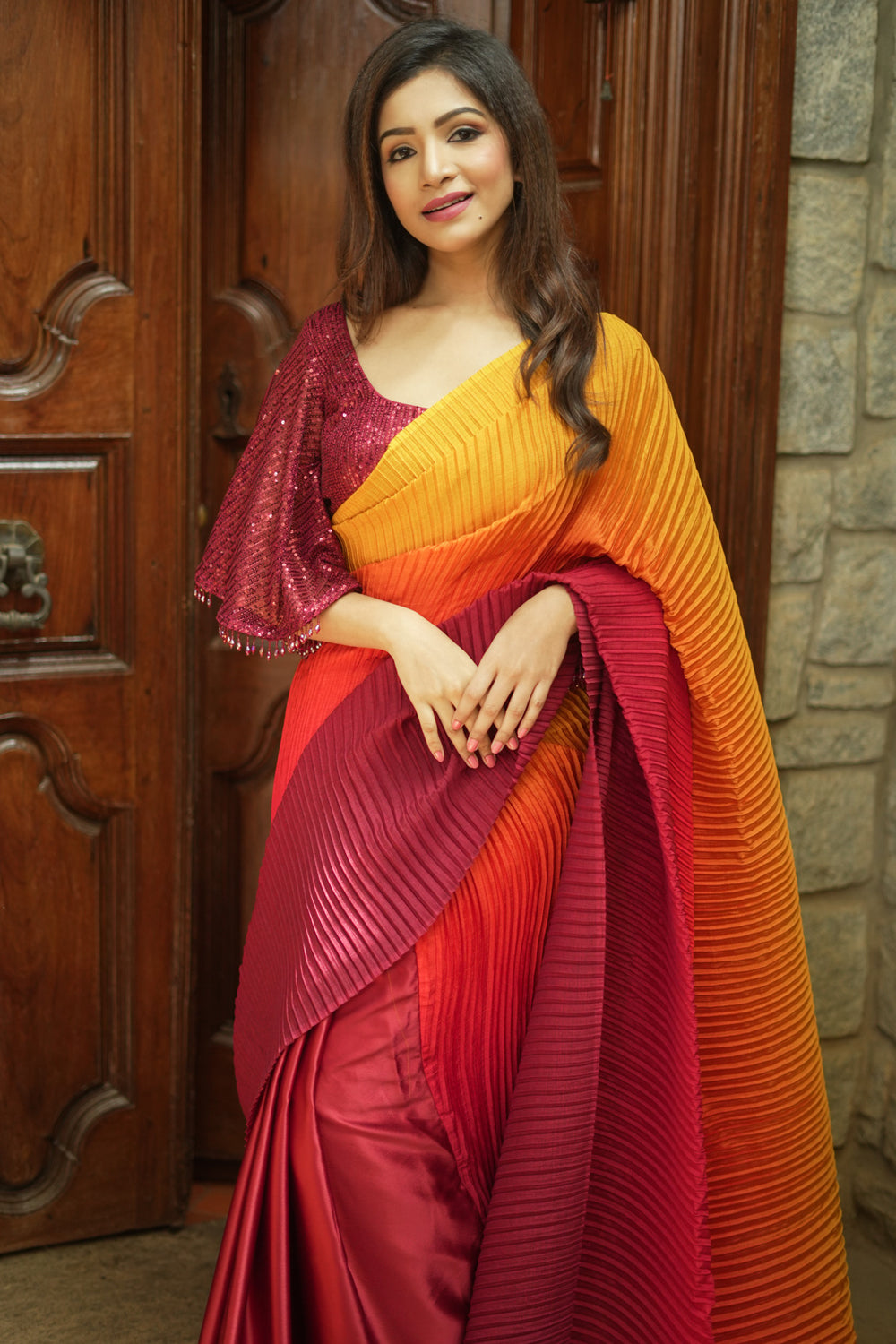 Pleated and satin half and half ombre shaded maroon and mustard saree.
