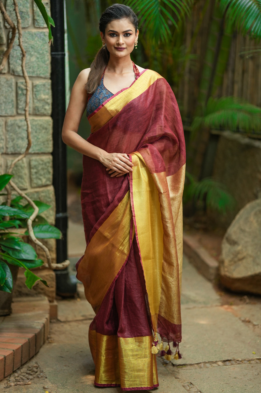 Maroon linen saree with wide antique gold border