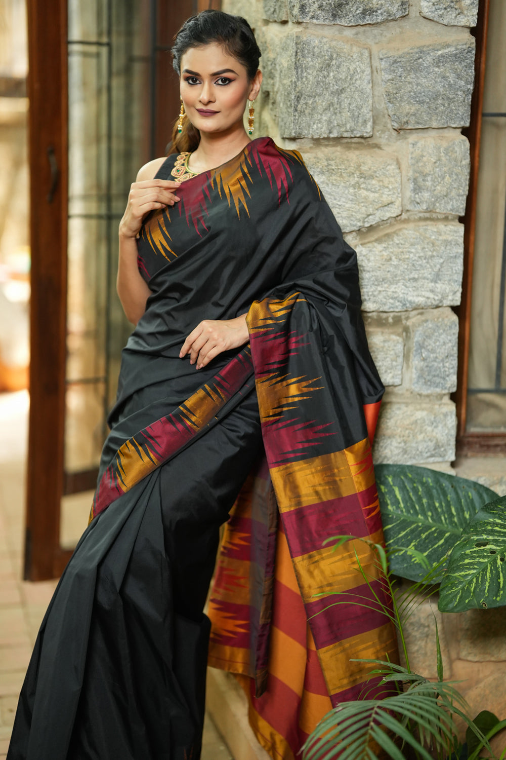 Black art silk saree with maroon and gold temple border