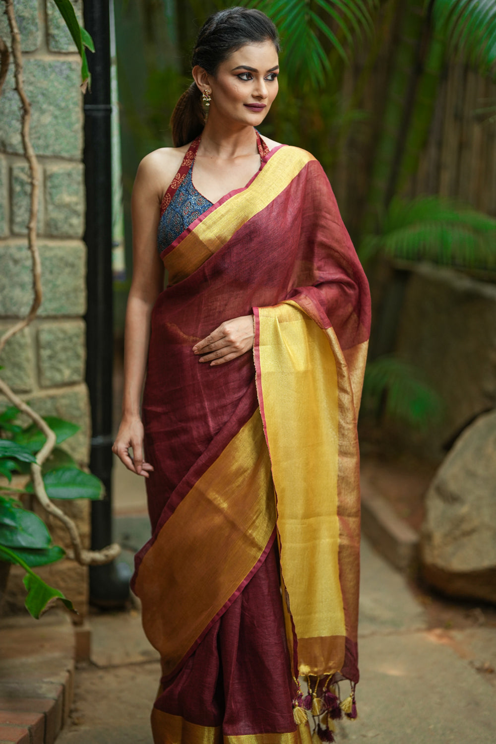Maroon linen saree with wide antique gold border