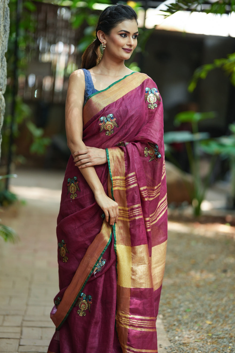 Dark purple linen saree with embroidered parrots motifs