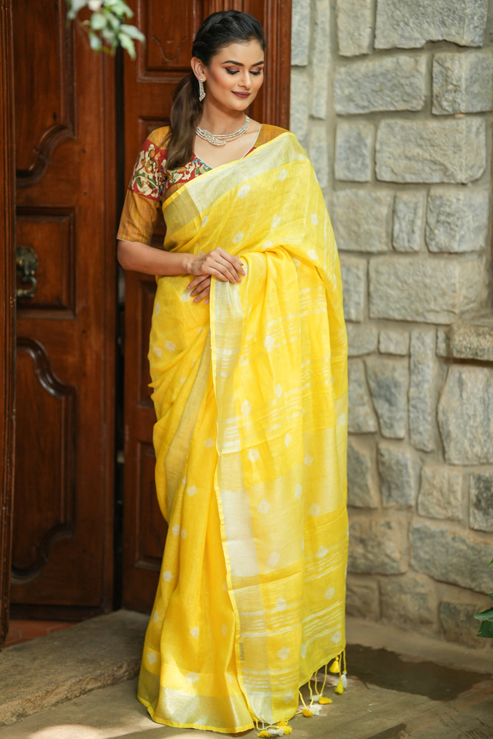 Yellow linen saree with silver border and buttas