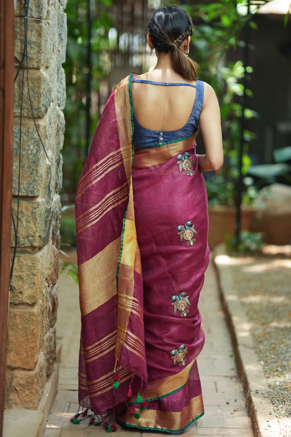 Dark purple linen saree with embroidered parrots motifs