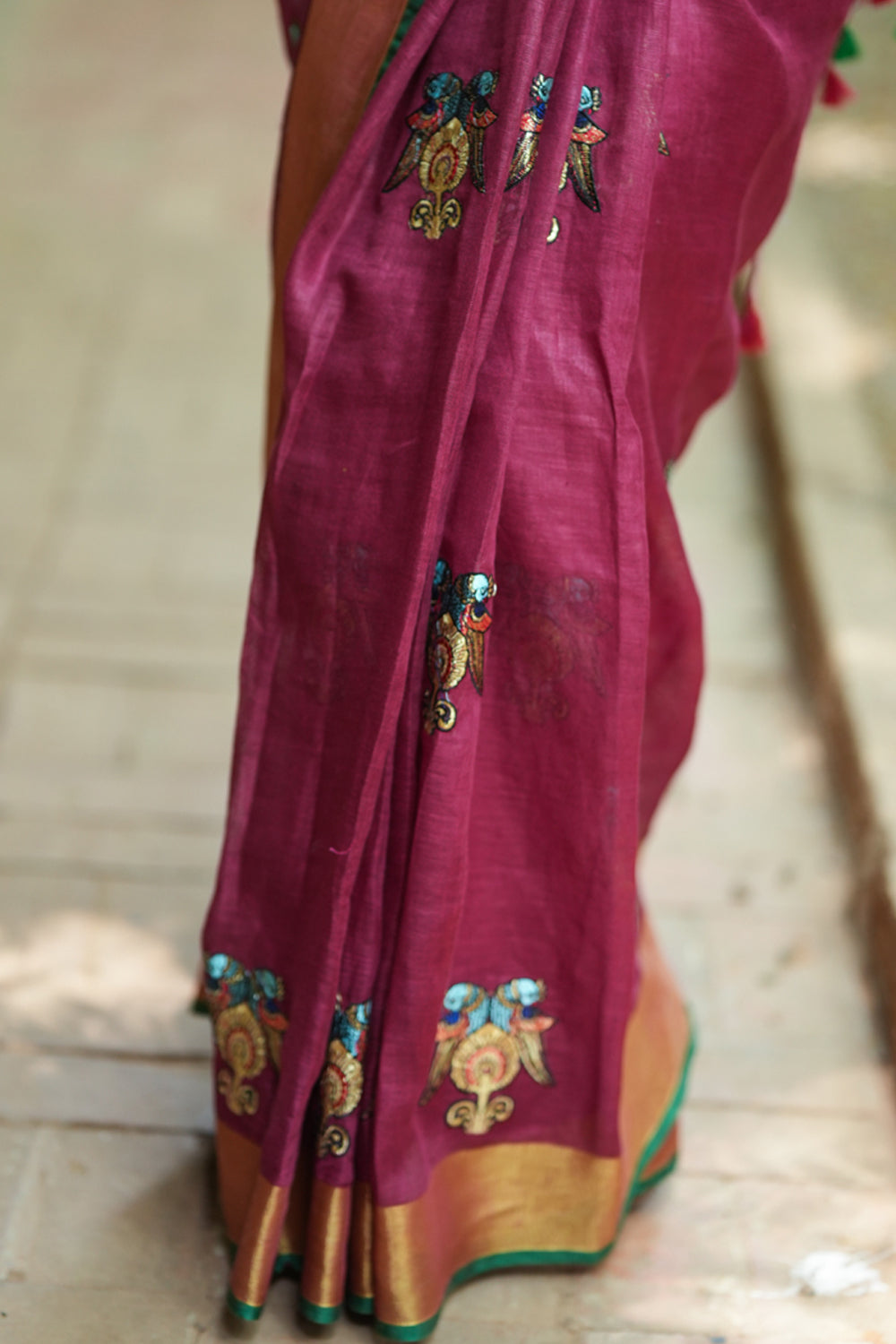 Dark purple linen saree with embroidered parrots motifs
