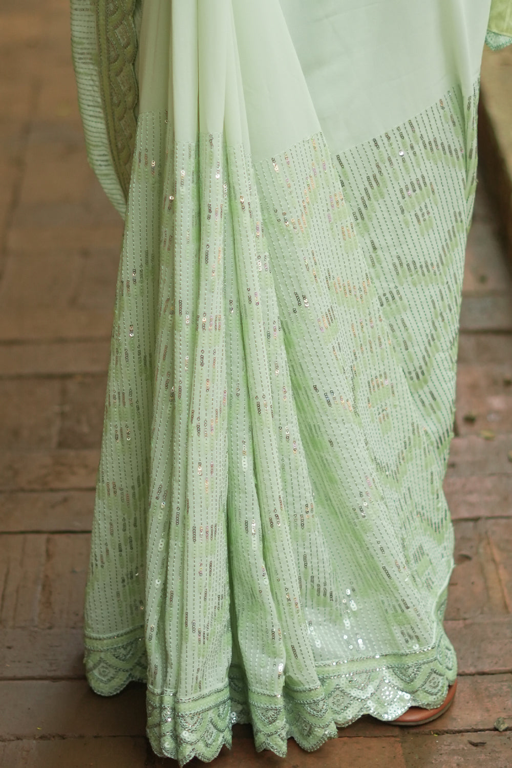 Pista green georgette sequin saree with scalloped edging