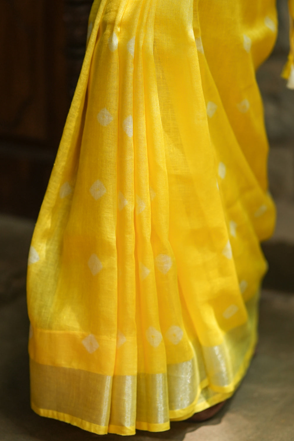 Yellow linen saree with silver border and buttas