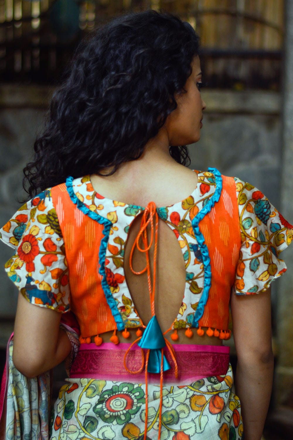 Orange ikat V neck blouse with cream floral kalamkari detailing