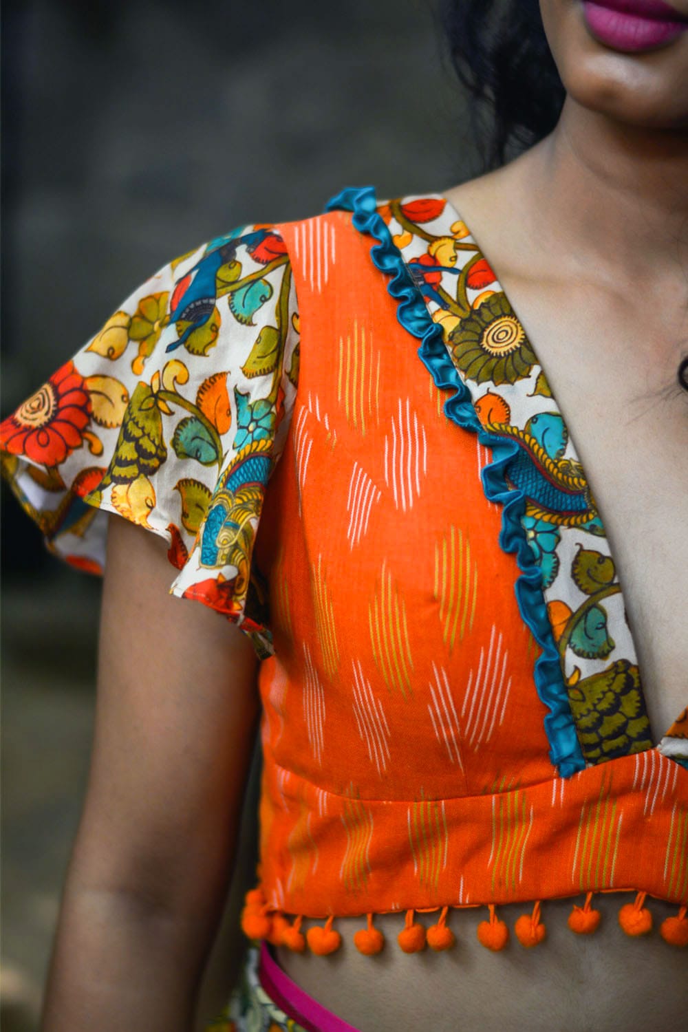 Orange ikat V neck blouse with cream floral kalamkari detailing
