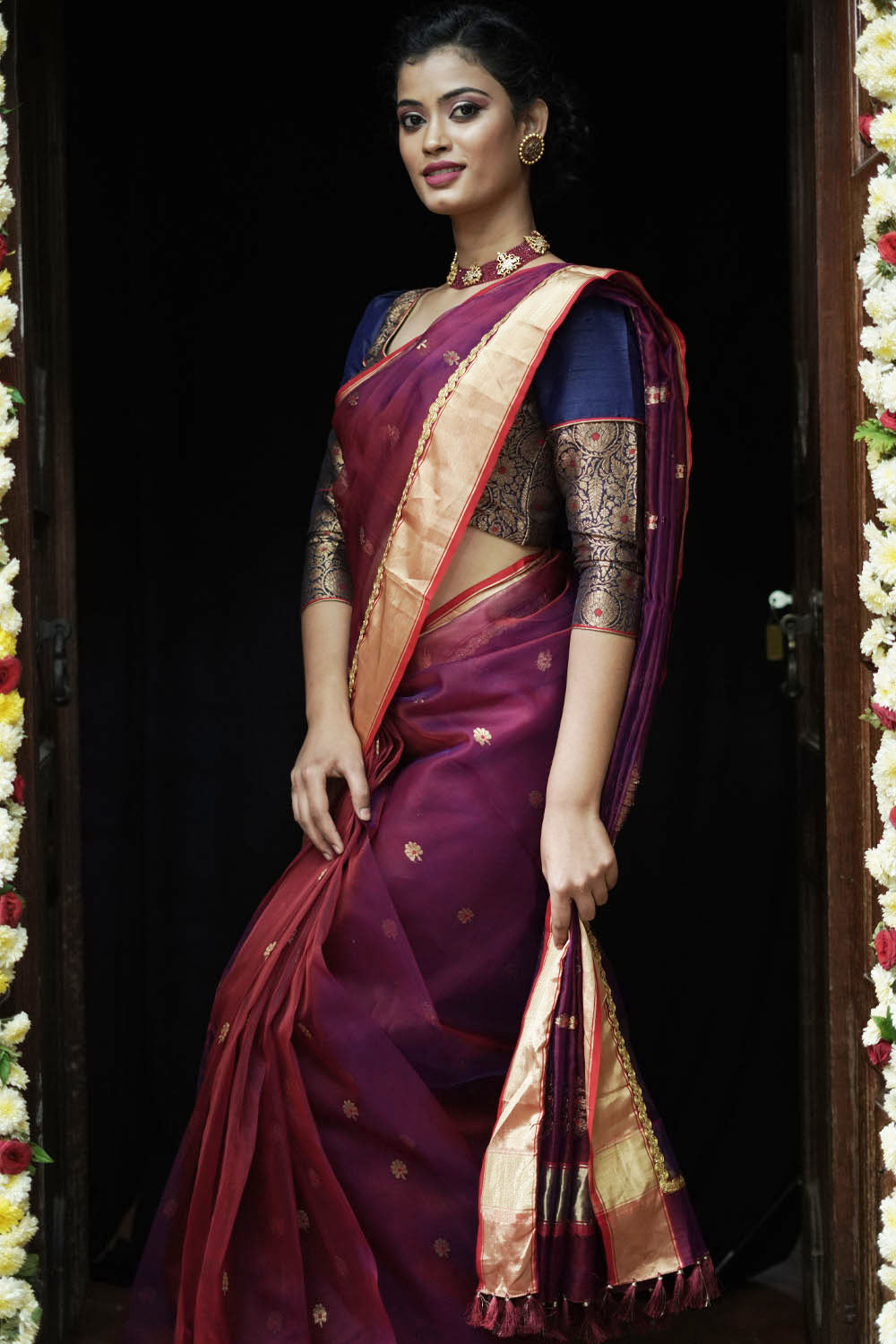 Plum coloured pure chanderi saree with gold zari buttis and gold tissue border with gold lace.