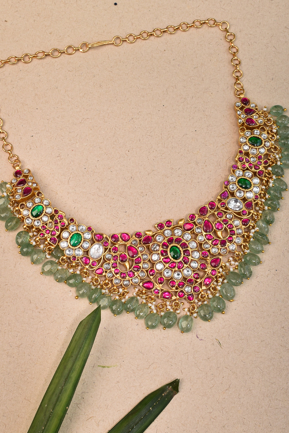 Jadau Intricately embellished Necklace and earring set with sage green dangling beads