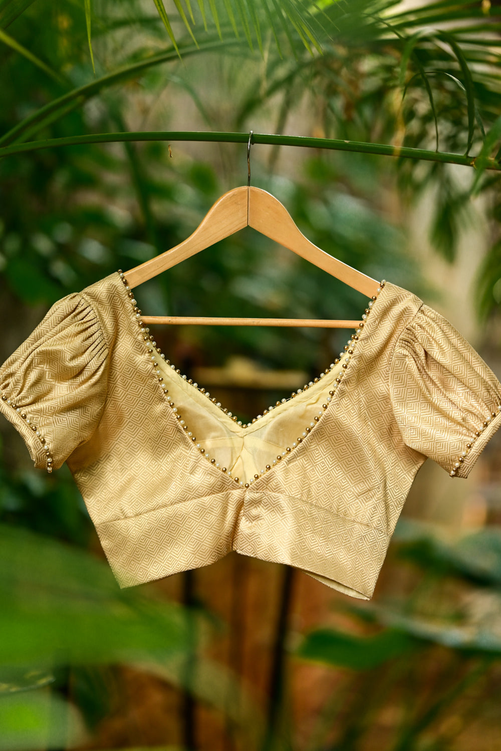 Gold brocade V neck blouse with puff sleeves with beads detailing.