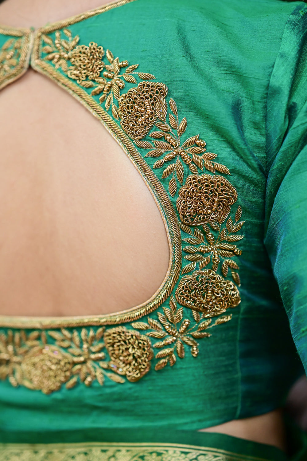 Sea green pure raw silk closed U neck blouse with antique tone zardosi detailing.