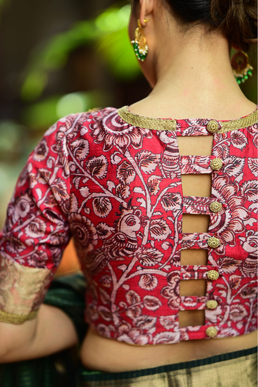Red floral pure raw silk closed neck short sleeved blouse with zari border.