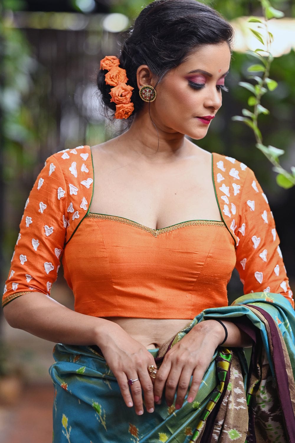 Orange raw silk sweetheart neck blouse with  hand painted and embroidered thumba poovu