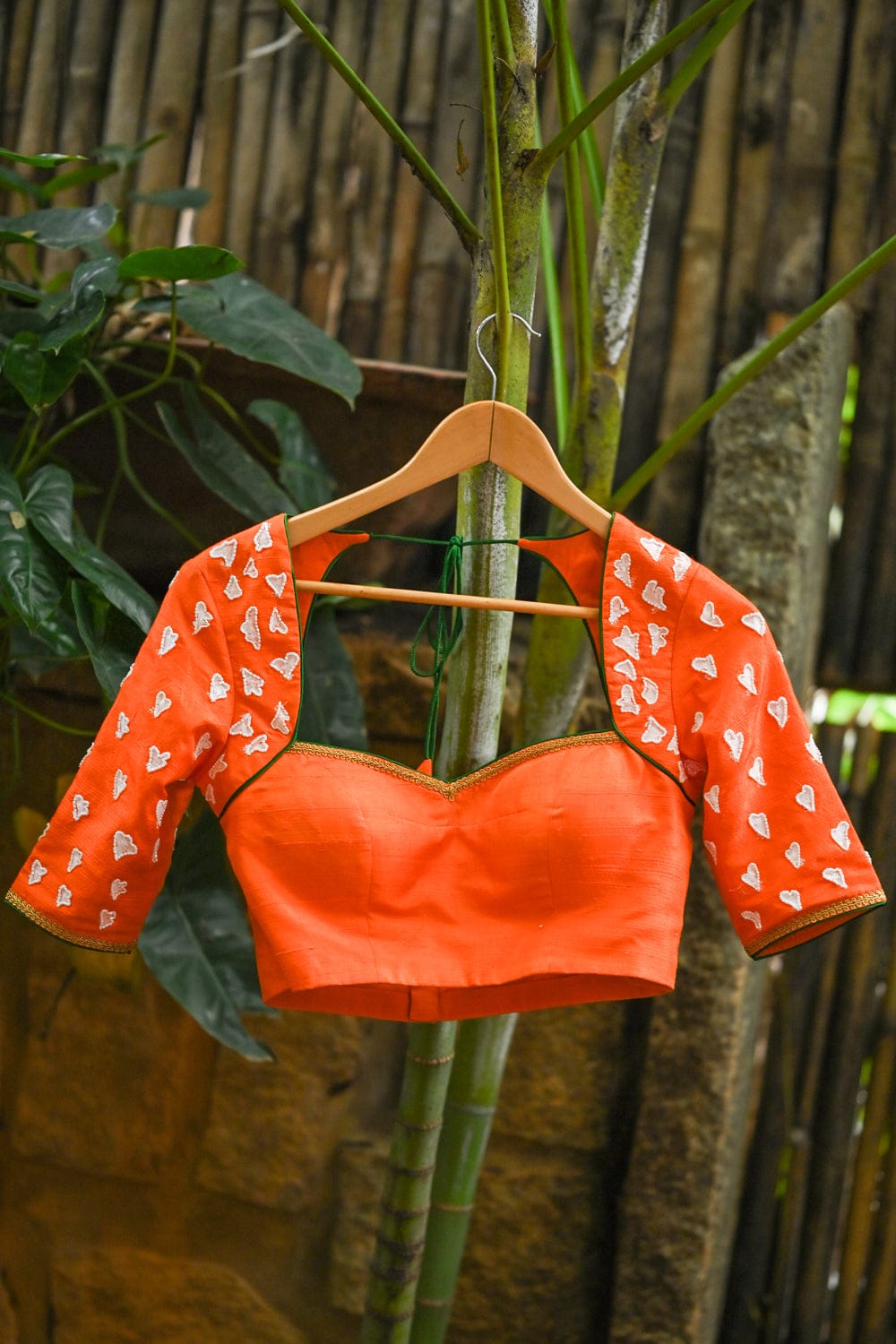 Orange raw silk sweetheart neck blouse with  hand painted and embroidered thumba poovu