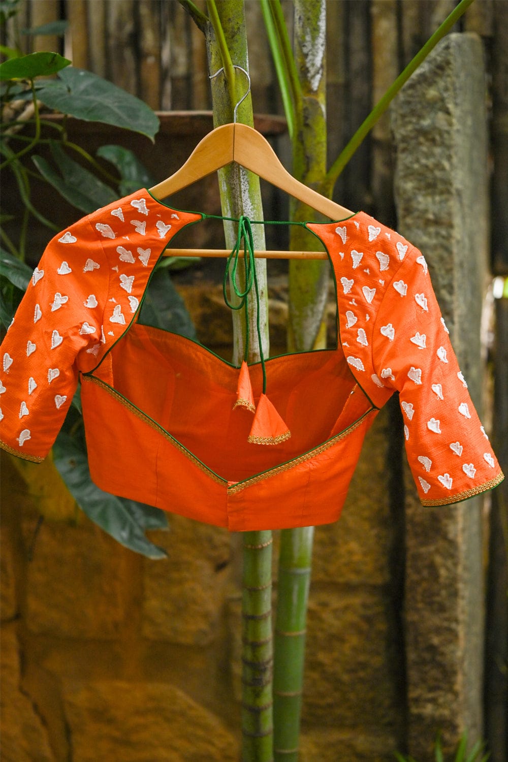 Orange raw silk sweetheart neck blouse with  hand painted and embroidered thumba poovu
