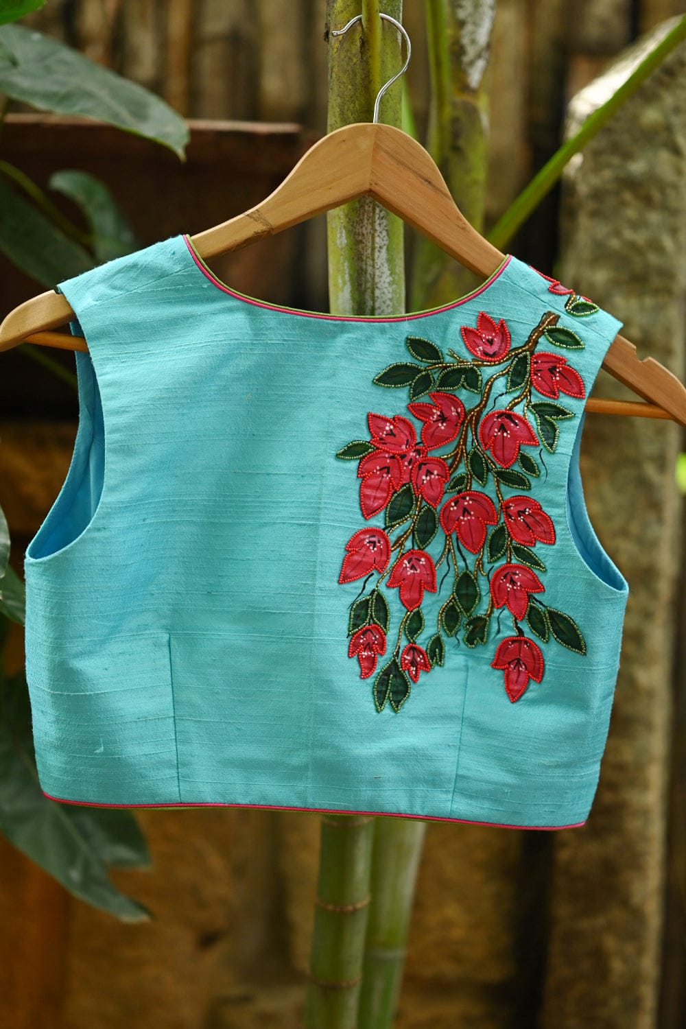 Light blue raw silk V neck blouse with hand painted and embroidered bougainvillea