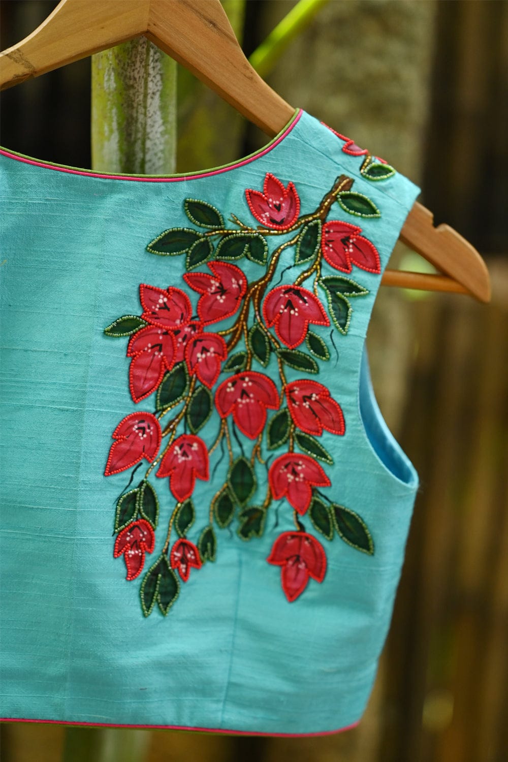 Light blue raw silk V neck blouse with hand painted and embroidered bougainvillea