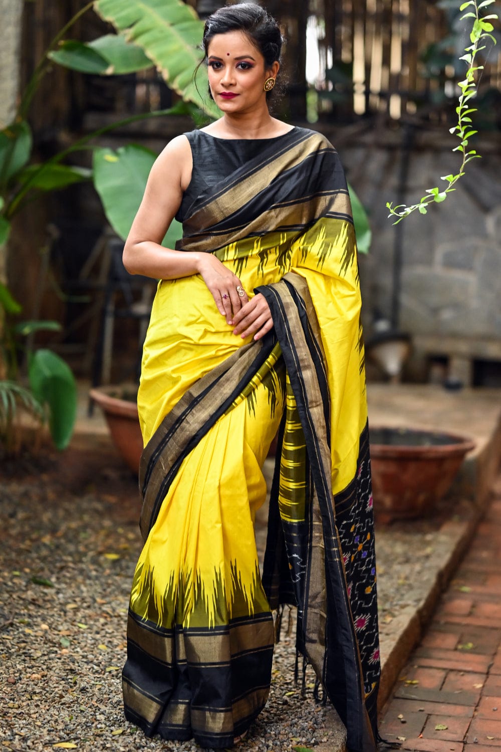 cadmium yellow pochampally pure silk saree with ebony black border and ikat pallu