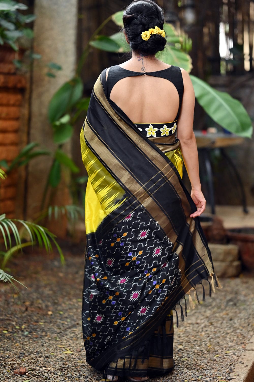 cadmium yellow pochampally pure silk saree with ebony black border and ikat pallu