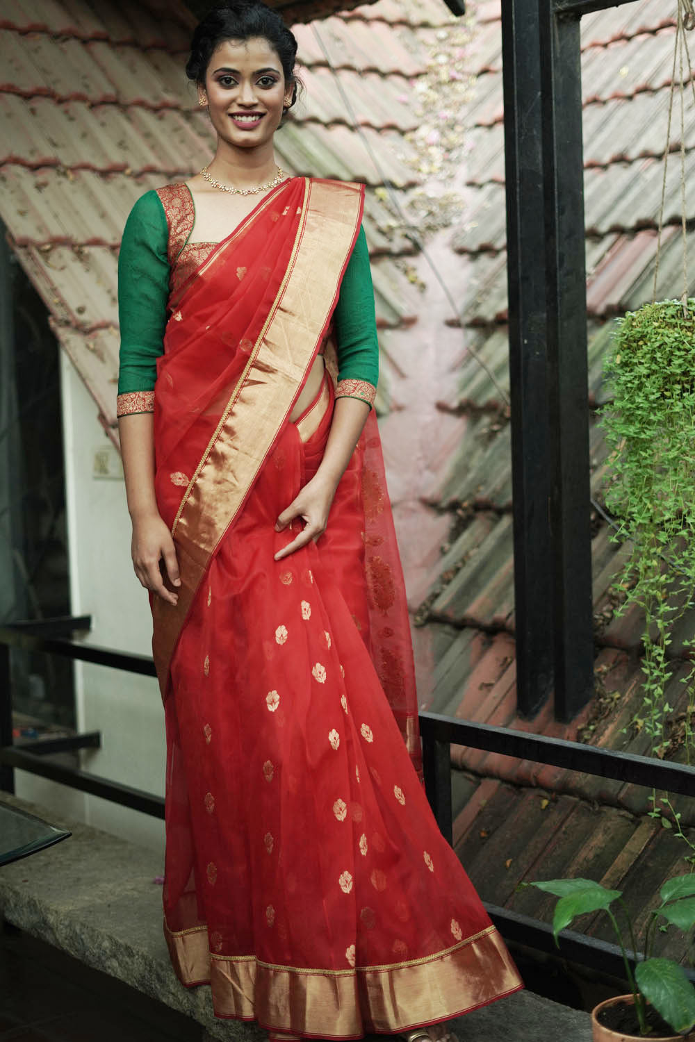 Ruby red chanderi with gold zari buttis and gold tissue border with gold lace.