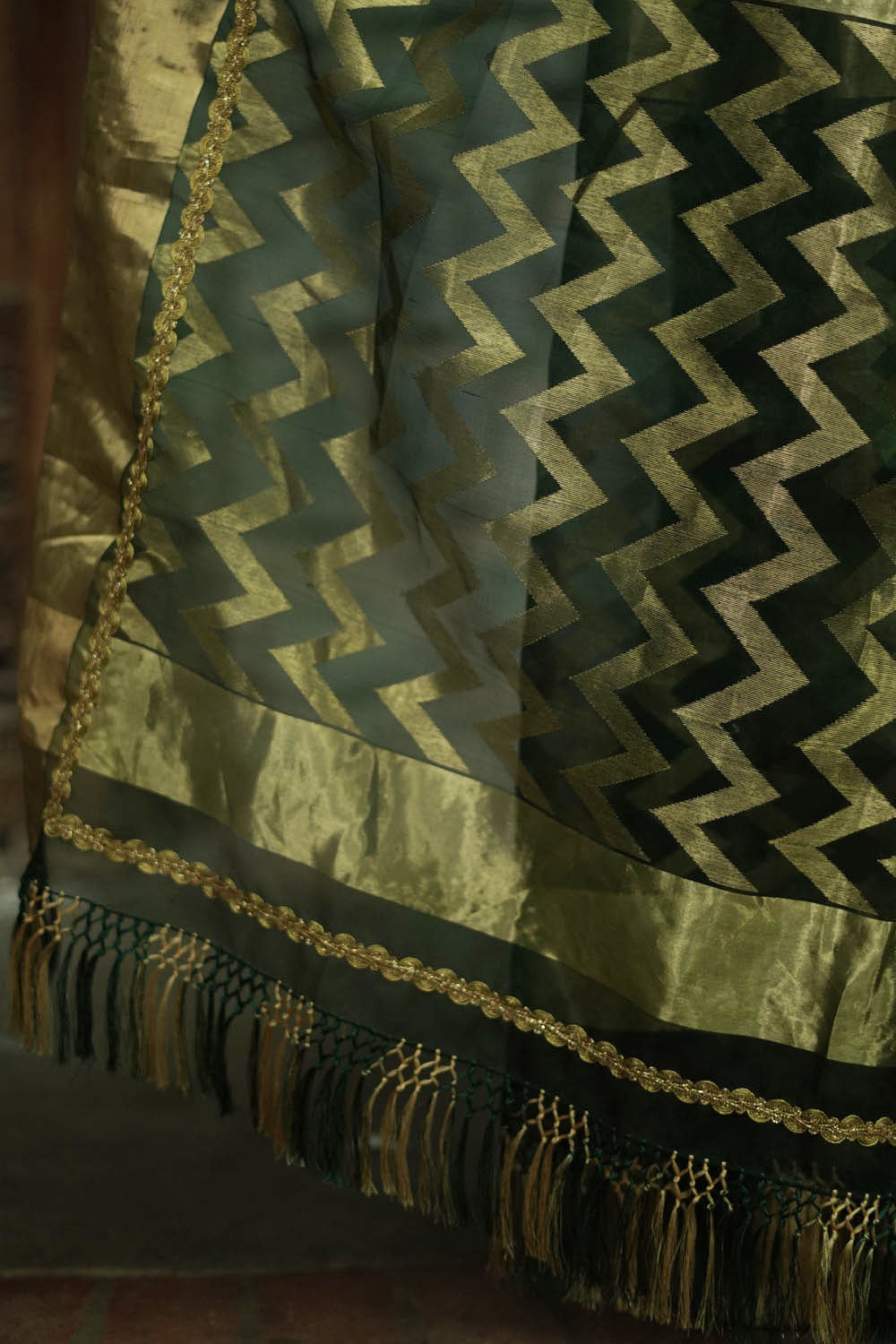 Bottle green chanderi saree with gold zari buttis and gold tissue border with gold lace.