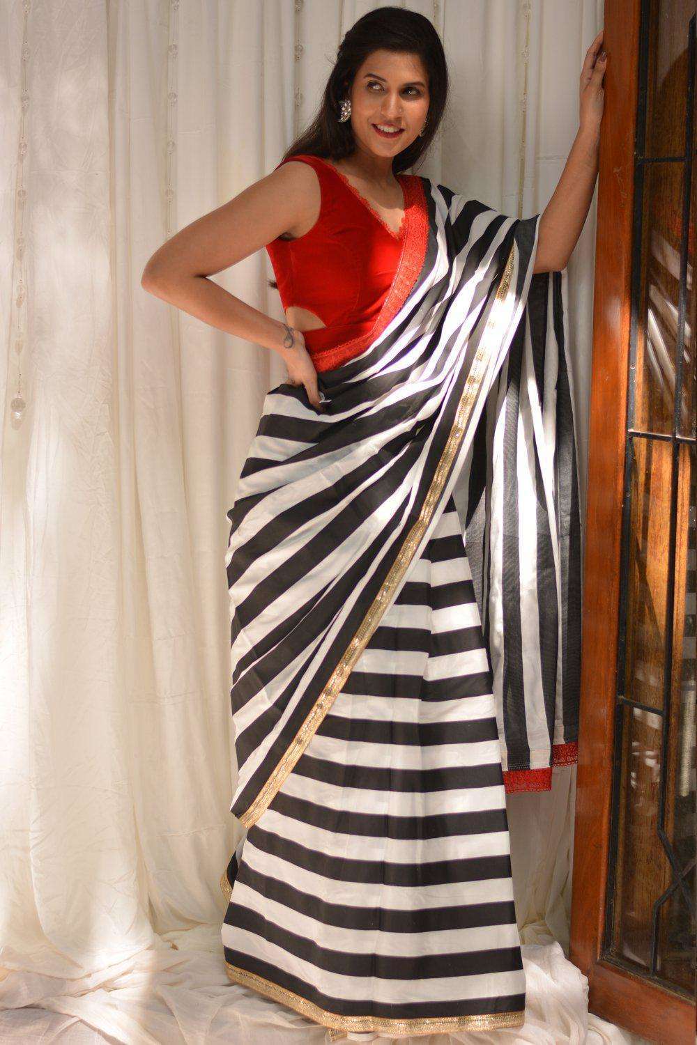 Black and white striped crepe saree with gold and red lace border - House of Blouse