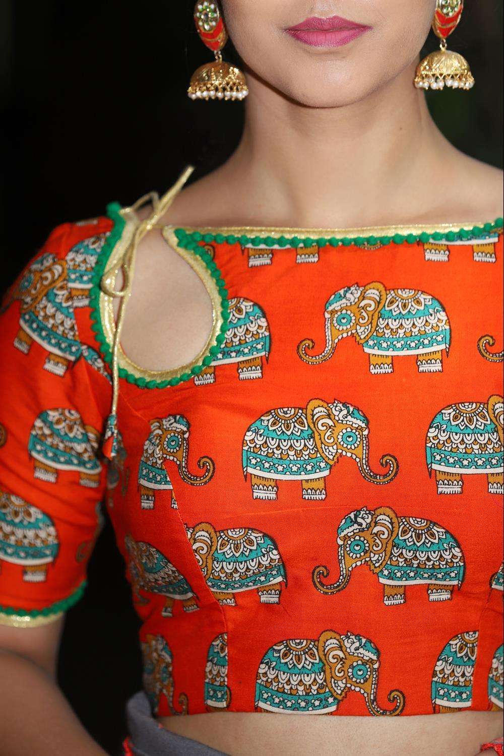Orange rayon boatneck blouse with printed Kalamkari elephant motifs and border detailing - House of Blouse