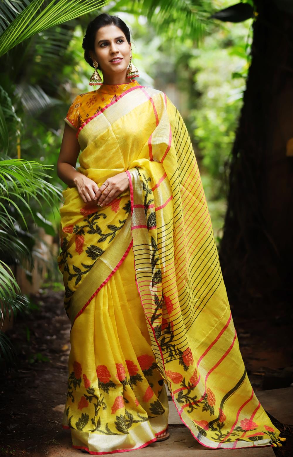 Yellow linen saree with floral weave and silver and pink border