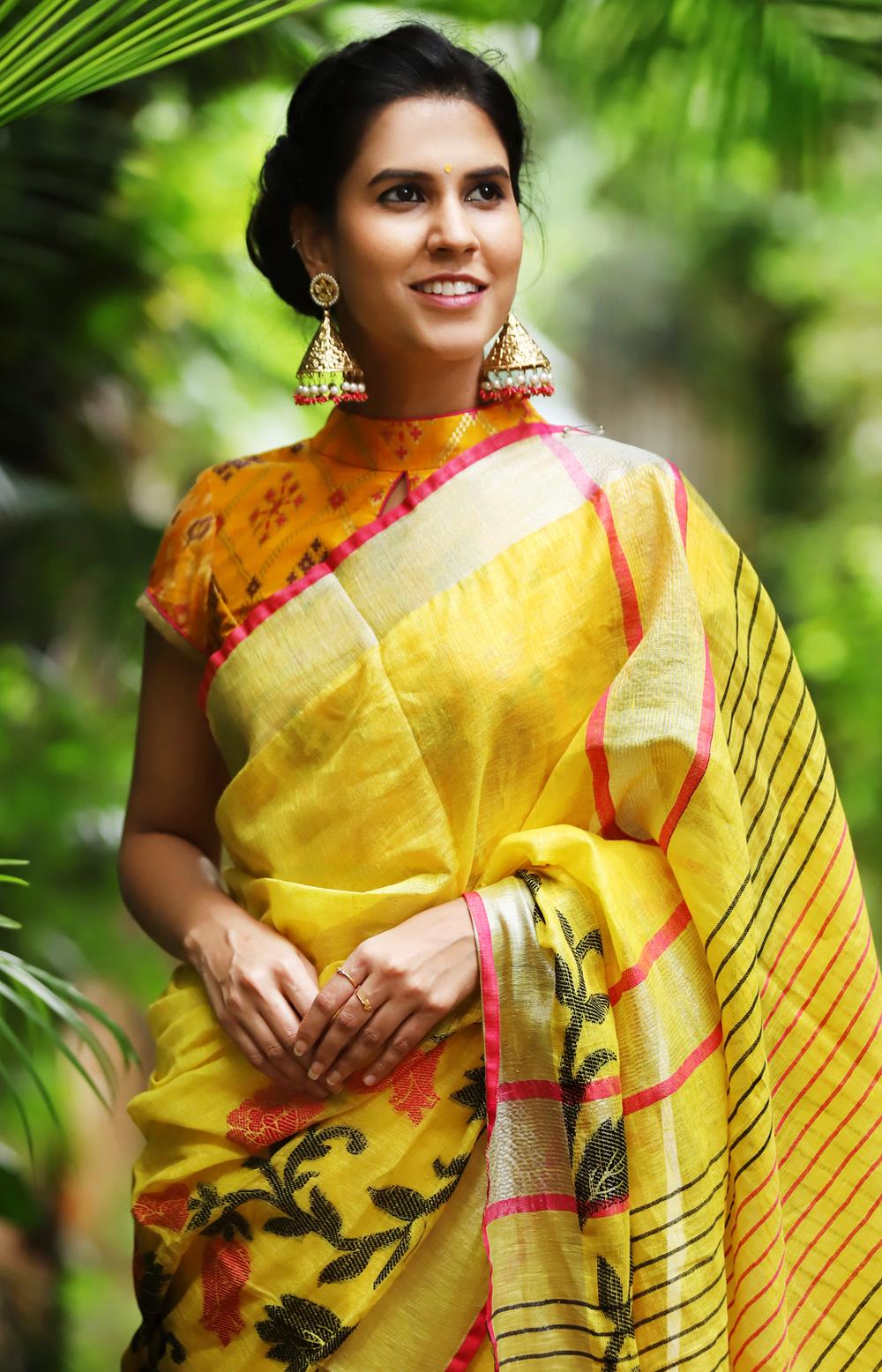 Yellow linen saree with floral weave and silver and pink border