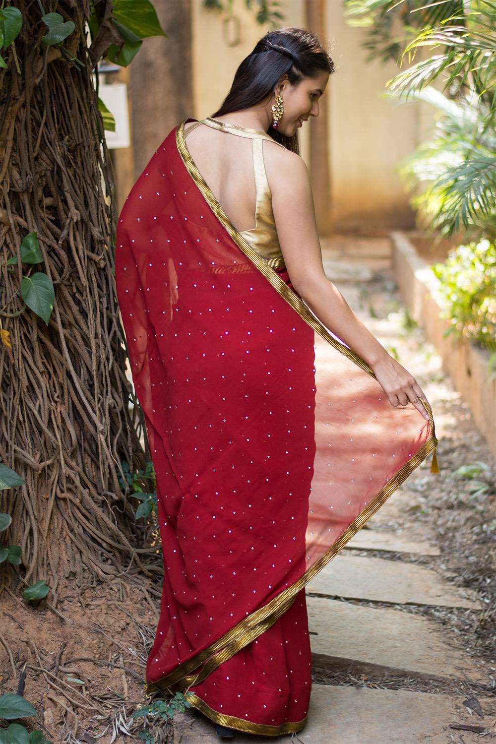 Deep red georgette saree with stone work and antique crushed gota border